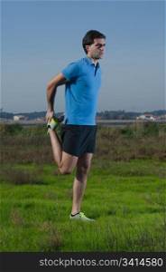 Male runner exercising outdoors on country landscape.