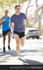 Male Runners Exercising On Suburban Street
