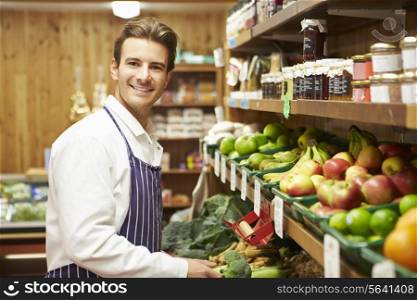 Male Sales Assistant At Vegetable Counter Of Farm Shop