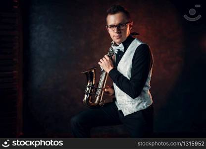 Male saxophonist playing classical jazz melody on sax. Jazz-man concept. Male saxophonist playing classical jazz on sax