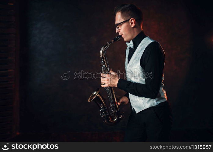 Male saxophonist playing classical jazz melody on sax. Jazz-man concept. Male saxophonist playing classical jazz on sax