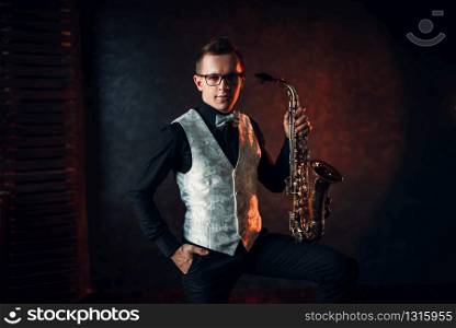 Male saxophonist posing with saxophone, jazz man. Jazz-man concept