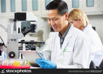 Male Scientist Using Tablet Computer In Laboratory