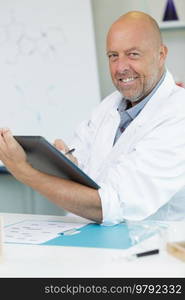 male scientist with tablet pc in lab