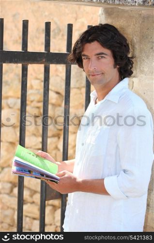 Male sightseer consulting a brochure