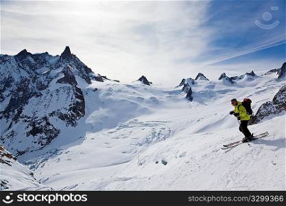 Male skier moving down in snow powder; envers du plan, vallA?e blanche, Chamonix, Mont Blanc massif, France, Europe.