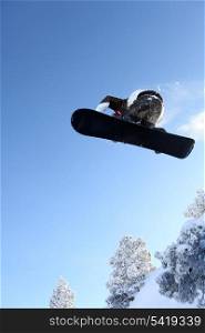 Male snowboarder performing trick