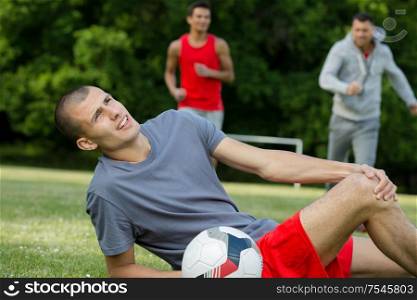 male soccer player suffering from knee injury
