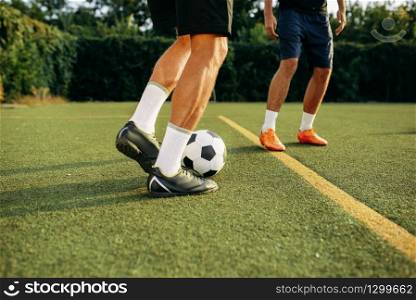 Male soccer players playing with ball on line on the field. Footballer on outdoor stadium, workout before football match