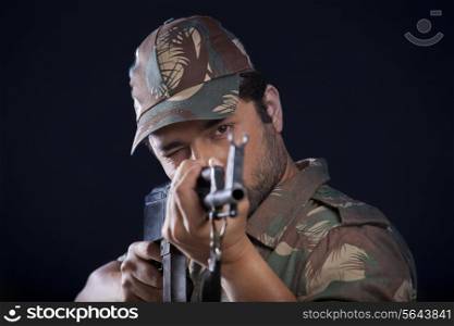 Male soldier aiming gun
