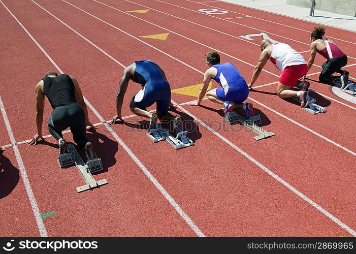 Male sprinters in starting blocks