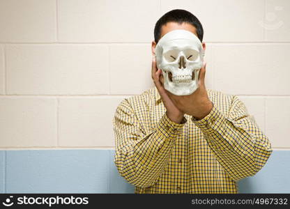 Male student holding a human skull