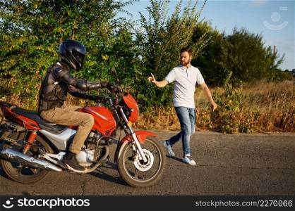 Male student in helmet and instructor, driving course on motordrome, motorcycle school. Training of motorcyclists beginners, biker practicing in motorschool. Driving course on motordrome, motorcycle school