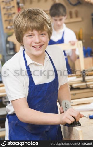 Male student learning woodworking