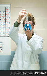 Male student performing an experiment