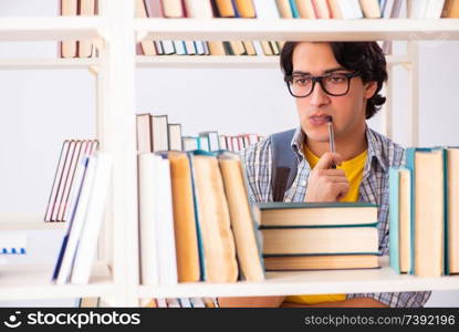 Male student preparing for exams at library 