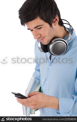 Male student sending text message holding books on white background