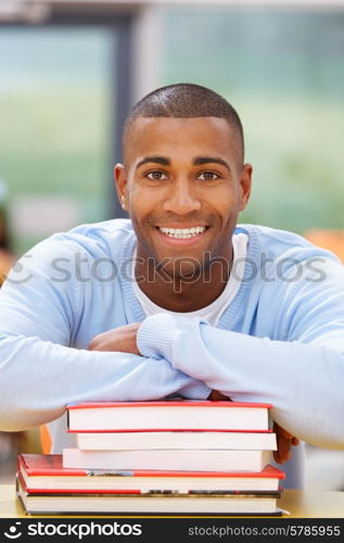 Male Student Studying In Classroom With Books