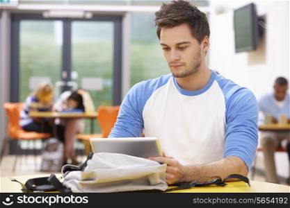 Male Student Studying In Classroom With Digital Tablet