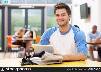 Male Student Studying In Classroom With Digital Tablet