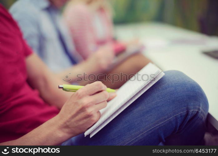 male student taking notes in classroom. business education concept, casual young businessman on seminar training