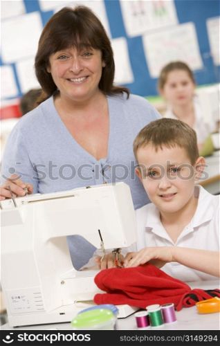 Male student using sewing machine with teacher