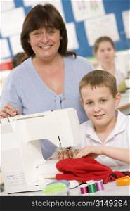 Male student using sewing machine with teacher