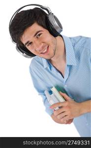 Male student with headphones holding books on white background