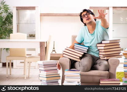 Male student with many books at home 