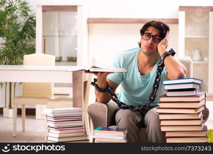 Male student with many books at home 