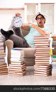 Male student with many books at home 