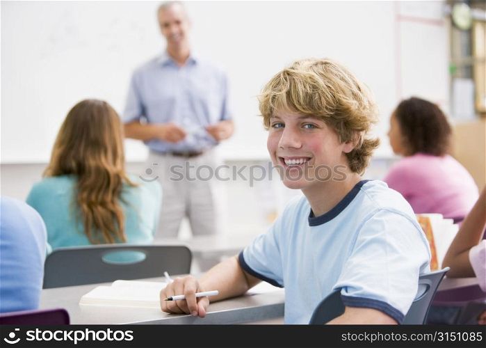 Male student with other students in classroom