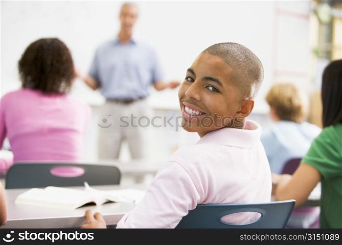 Male student with other students in classroom