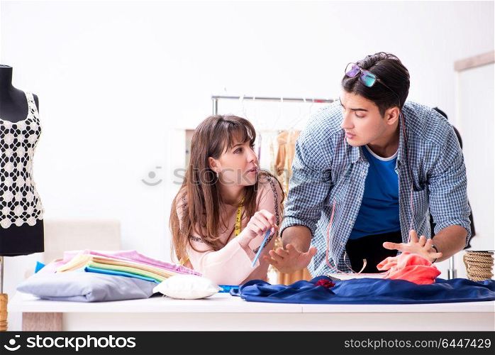 Male tailor with female student in workshop