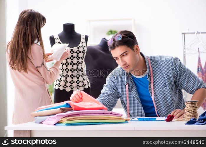 Male tailor with female student in workshop