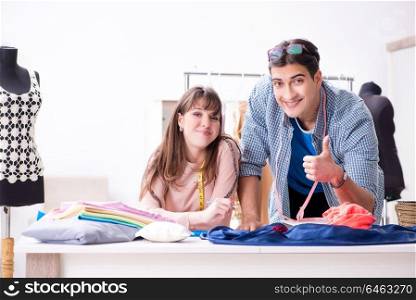 Male tailor with female student in workshop
