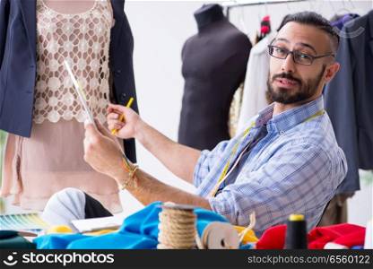 Male tailor working in the workshop on new designs