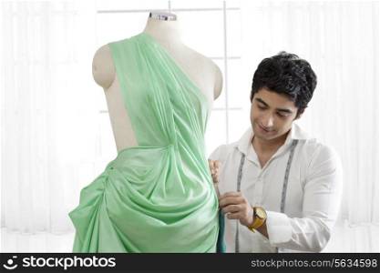 Male tailor working on dressmaker&rsquo;s form