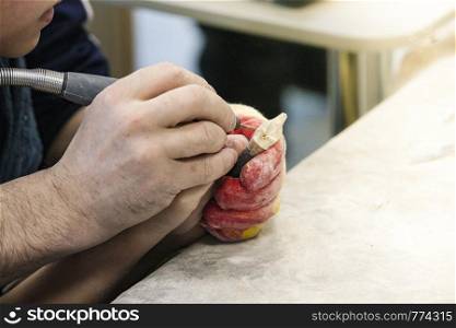 male teacher and his little student make a hand-made walrus bone souvenir