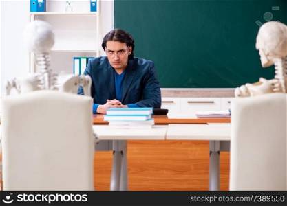Male teacher and skeleton student in the classroom. Male teacher and skeleton student in the classroom 