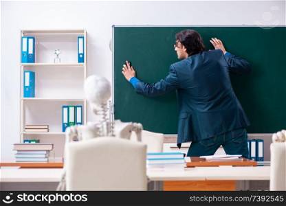 Male teacher and skeleton student in the classroom. Male teacher and skeleton student in the classroom 