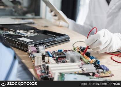 male technician examining mother board with digital multimeter . Resolution and high quality beautiful photo. male technician examining mother board with digital multimeter . High quality and resolution beautiful photo concept