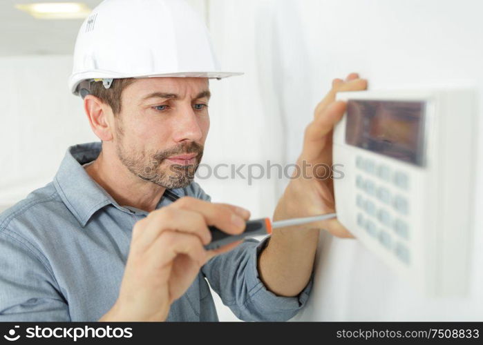 male technician installing an air conditioner