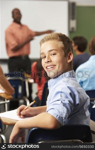 Male Teenage Pupil In Classroom