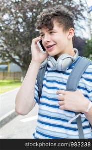 Male Teenage Student Outside College Building Talking On Mobile Phone