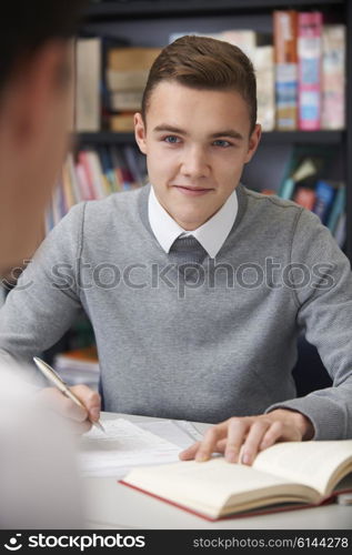 Male Teenage Student Working In Classroom