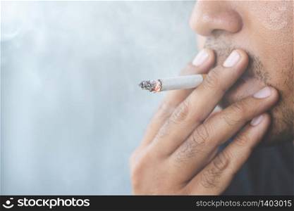 Male teenagers are smoking, cigarettes are harmful to health.