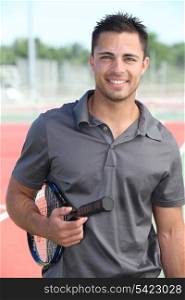 Male tennis player holding racquet