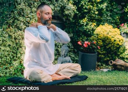 Male therapist performing reiki therapy self-treatment holding hands over his shoulders. Alternative therapy concept. . Reiki Self-Healing Treatment