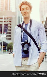 Male tourist in city. Happy male tourist in casual clothes in city walking